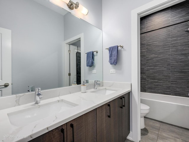 full bathroom with vanity, tiled shower / bath, tile patterned floors, and toilet