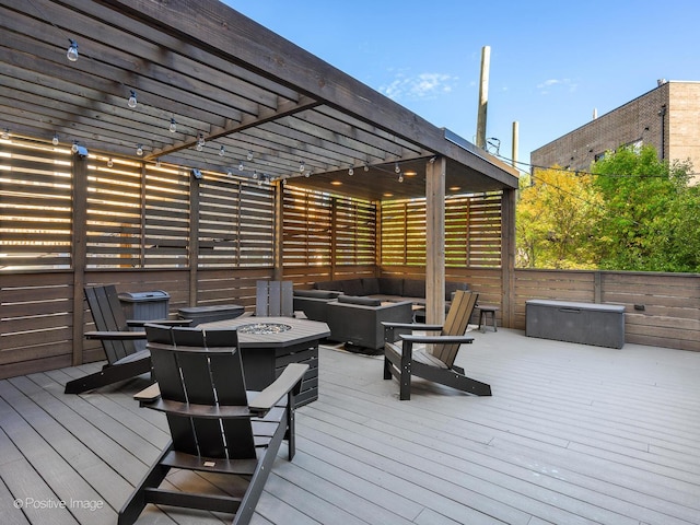 wooden deck featuring a pergola and an outdoor fire pit