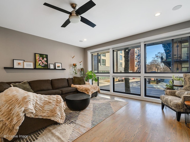 living room with hardwood / wood-style floors and ceiling fan