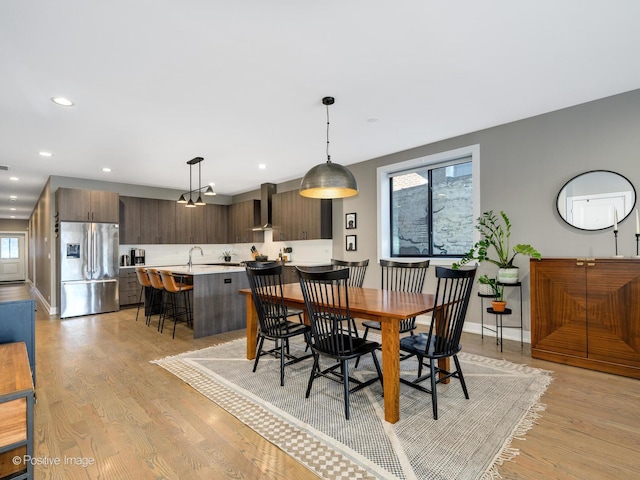 dining room featuring sink and light wood-type flooring