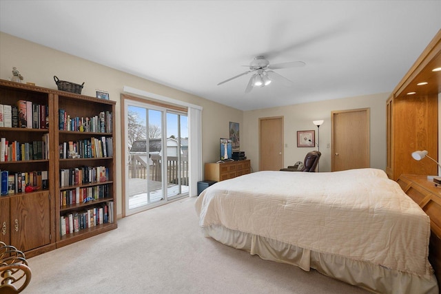 carpeted bedroom featuring access to exterior and ceiling fan