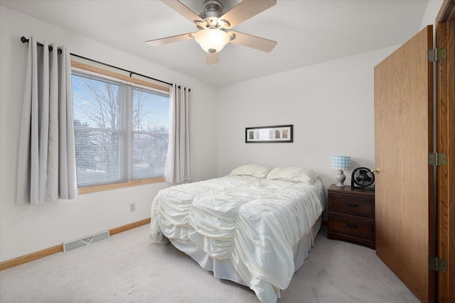 bedroom with ceiling fan and light carpet