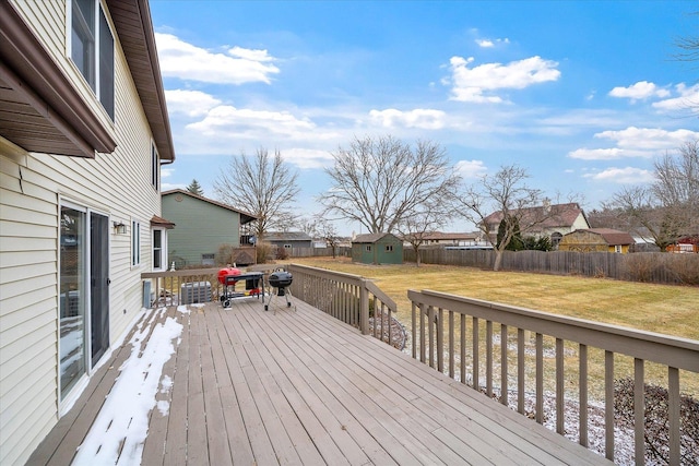 deck with a storage shed, central AC, and a lawn