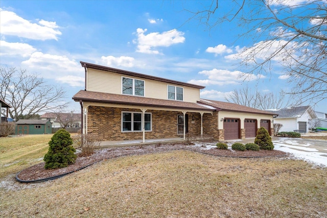 front of property with a porch, a garage, and a front lawn