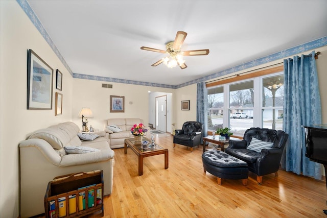 living room with ceiling fan and light hardwood / wood-style floors