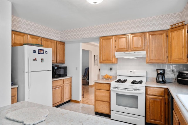 kitchen featuring decorative backsplash and black appliances