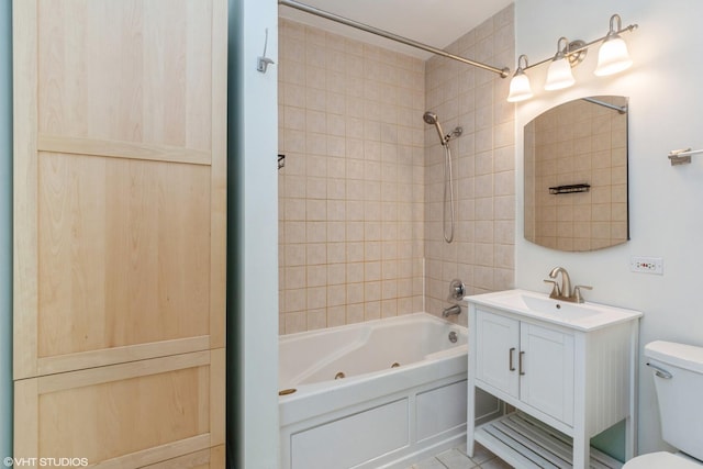 full bathroom featuring vanity, toilet, and tiled shower / bath combo