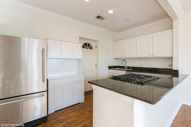 kitchen with white cabinetry, sink, ornamental molding, kitchen peninsula, and stainless steel appliances