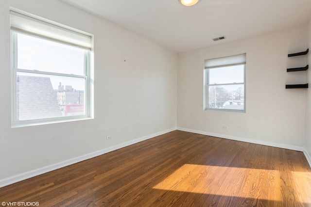 empty room with hardwood / wood-style flooring