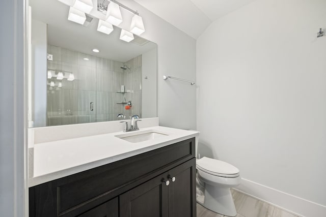 bathroom featuring vanity, toilet, and an enclosed shower