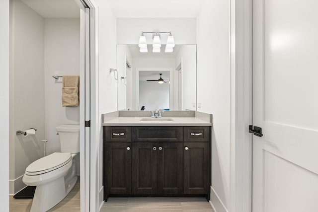 bathroom with vanity, wood-type flooring, and toilet