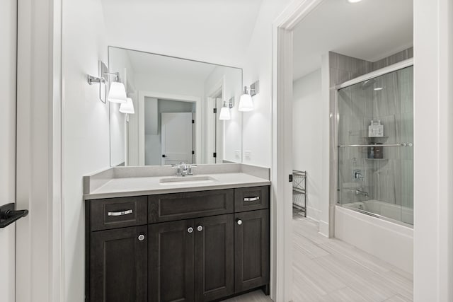 bathroom with vanity and combined bath / shower with glass door