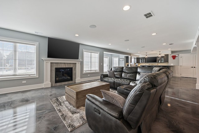 living room featuring a tiled fireplace