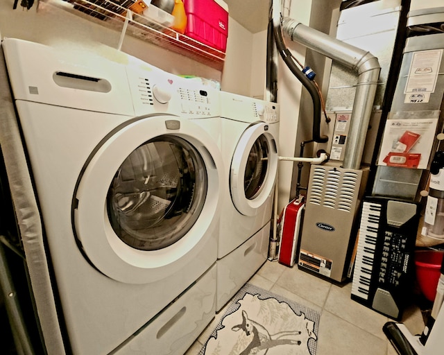 washroom featuring washer and dryer and light tile patterned flooring