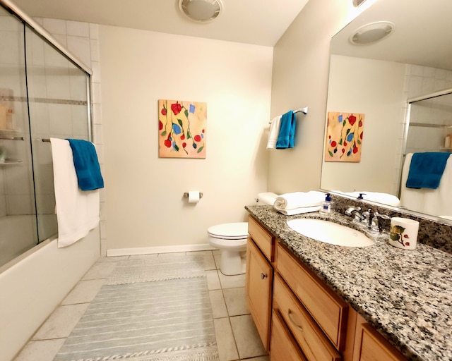 full bathroom featuring toilet, vanity, bath / shower combo with glass door, and tile patterned flooring