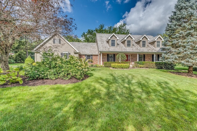 new england style home featuring a front lawn