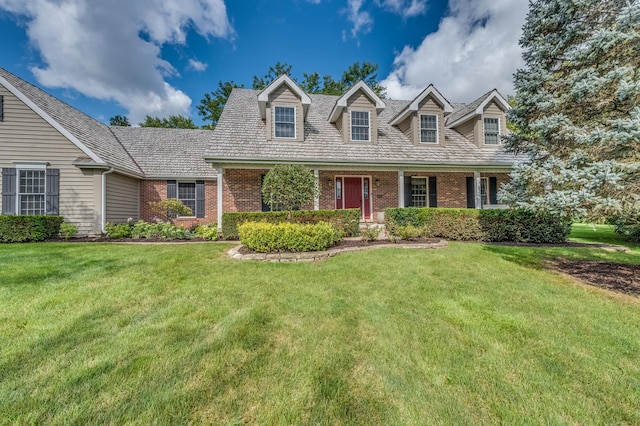 cape cod house featuring a front lawn