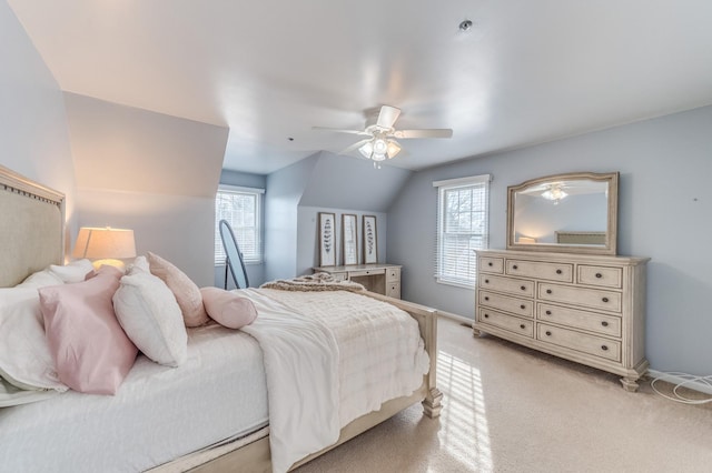 bedroom featuring multiple windows, lofted ceiling, light colored carpet, and ceiling fan