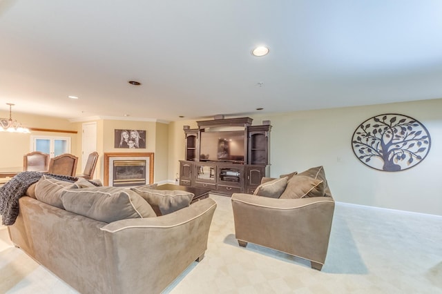 living room with light colored carpet and a notable chandelier