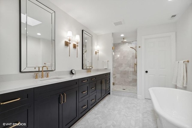 full bath featuring a sink, double vanity, a soaking tub, and a shower stall