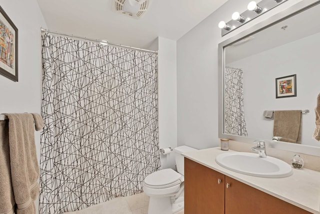 bathroom featuring vanity, tile patterned floors, and toilet