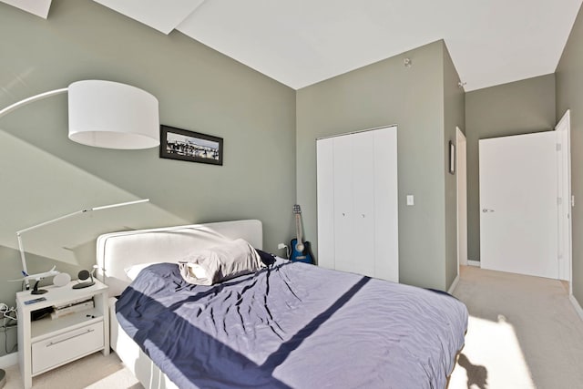 bedroom with light carpet and a closet