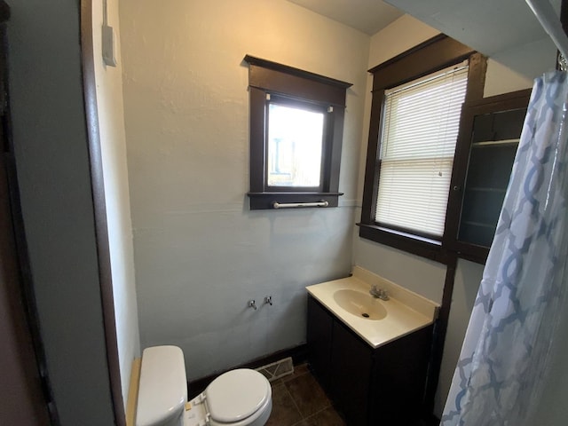 bathroom featuring vanity, tile patterned flooring, curtained shower, and toilet