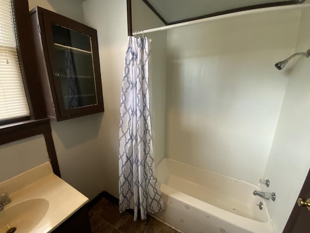 bathroom featuring tile patterned flooring, vanity, and shower / tub combo with curtain