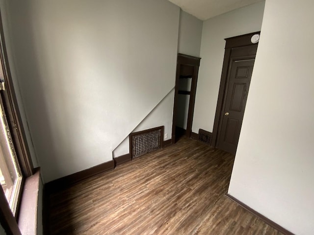 spare room with dark wood-type flooring