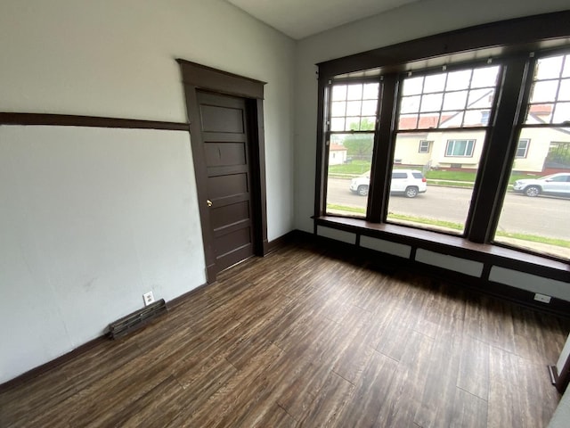 empty room with dark hardwood / wood-style floors