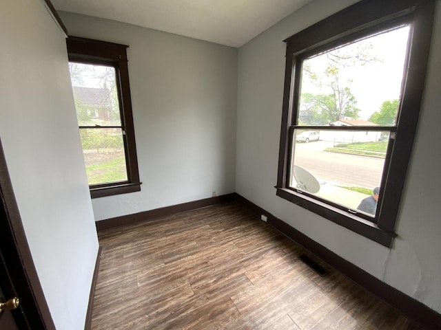 unfurnished room featuring hardwood / wood-style flooring