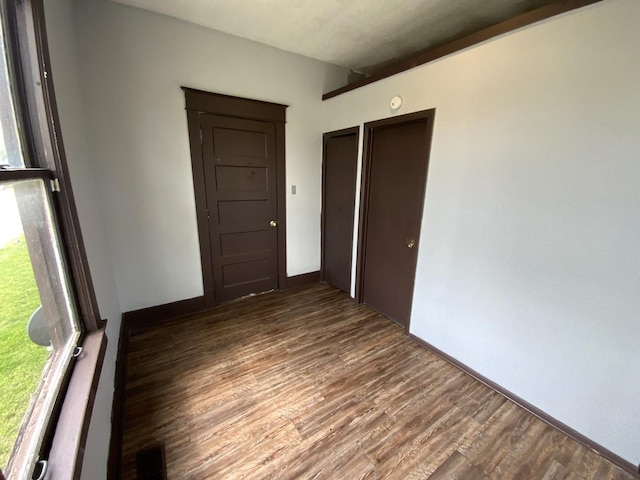 empty room with dark hardwood / wood-style flooring