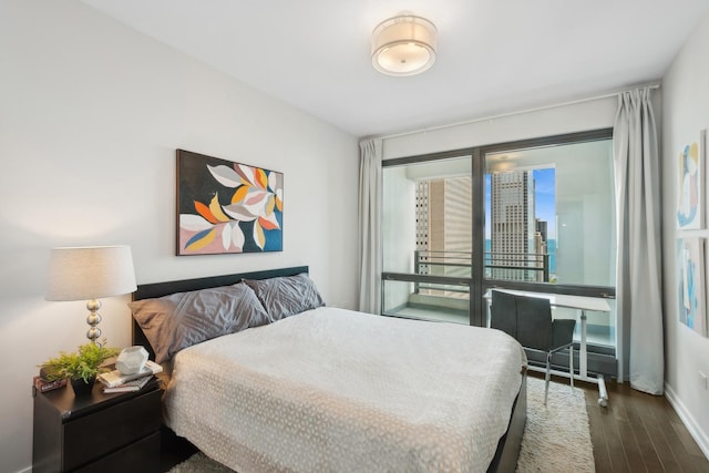 bedroom with dark hardwood / wood-style floors