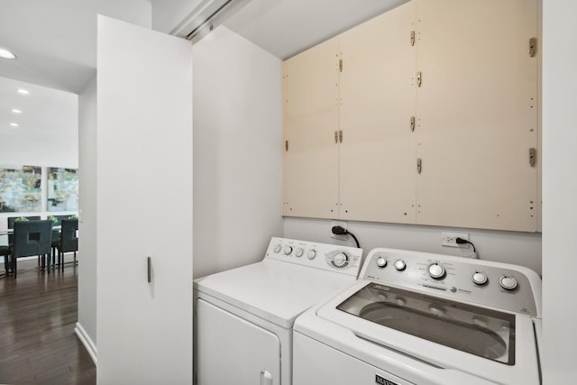 washroom with washer and dryer and dark hardwood / wood-style floors