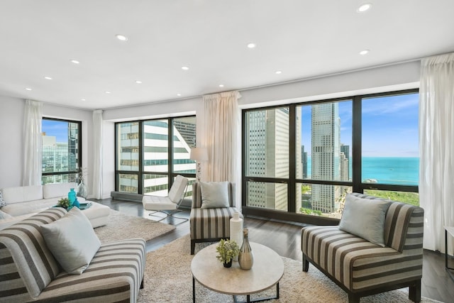 living room featuring a water view and hardwood / wood-style floors