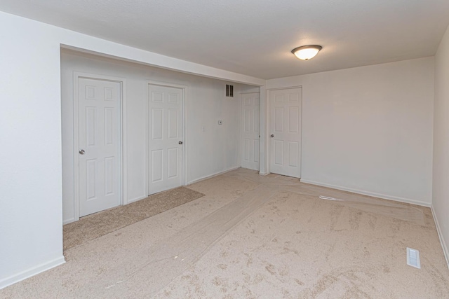 empty room featuring light colored carpet