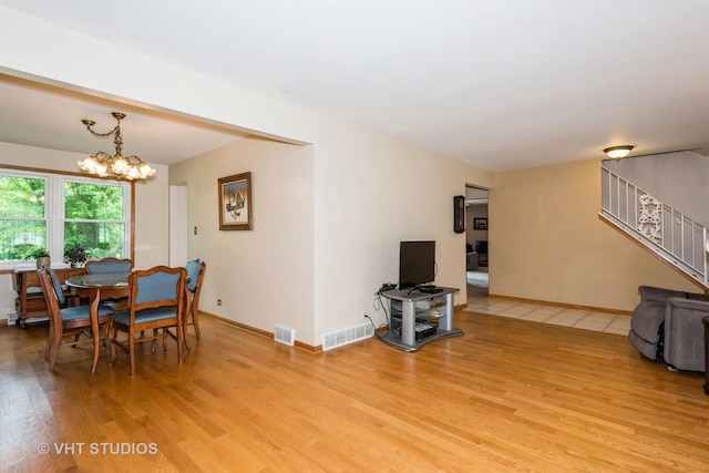 dining room with a chandelier and light hardwood / wood-style flooring