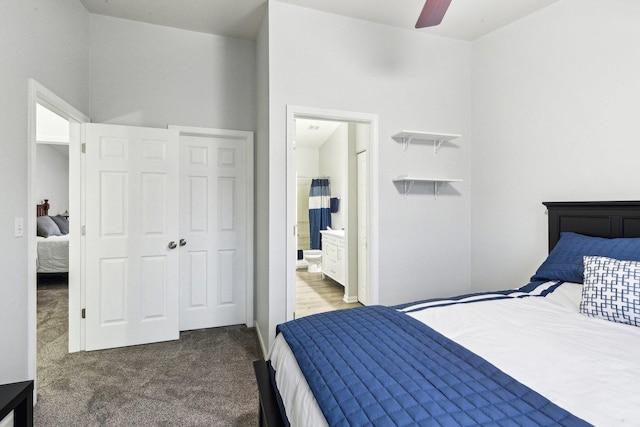 bedroom featuring ensuite bathroom and carpet floors