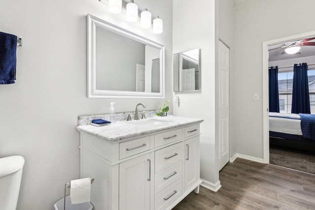 bathroom with vanity, ceiling fan, wood-type flooring, and toilet