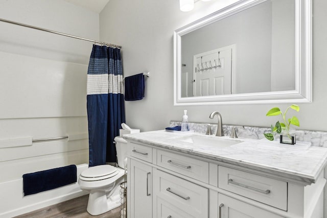 full bathroom featuring vanity, hardwood / wood-style flooring, toilet, and shower / bath combo with shower curtain