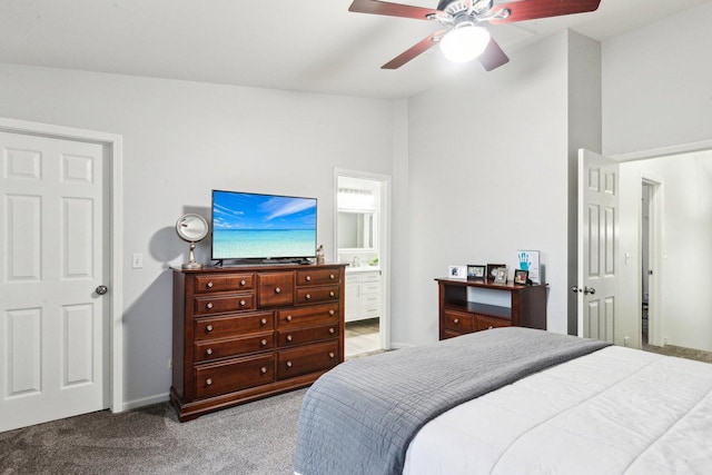 carpeted bedroom with ensuite bath, vaulted ceiling, and ceiling fan