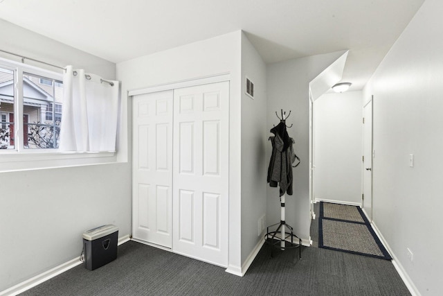 interior space featuring dark colored carpet