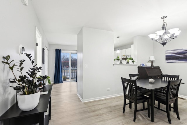 dining space with an inviting chandelier and light wood-type flooring