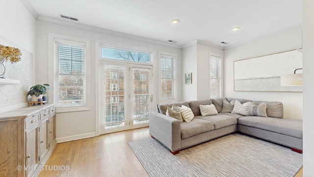 living room featuring ornamental molding and light hardwood / wood-style floors