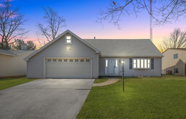 view of front facade featuring a garage and a lawn