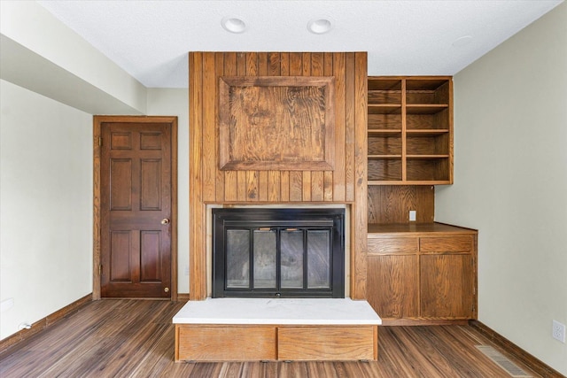 unfurnished living room featuring dark wood-type flooring