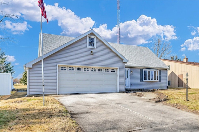 view of front of property featuring a garage and a front yard