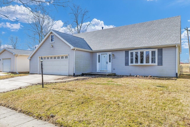 view of front of property featuring a garage and a front lawn