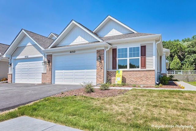 craftsman-style home with a garage and a front lawn