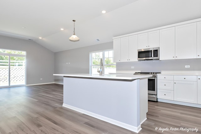 kitchen featuring white cabinetry, stainless steel appliances, and pendant lighting